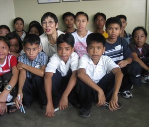  フィリピンの学生を支援する角谷さん（「日比パガサの会」提供）