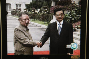 ８月２７日、中国の吉林省長春市で胡錦濤国家主席（右）と握手する北朝鮮の金正日労働党総書記（３０日夜の中国中央テレビのニュースから）（C）時事通信社